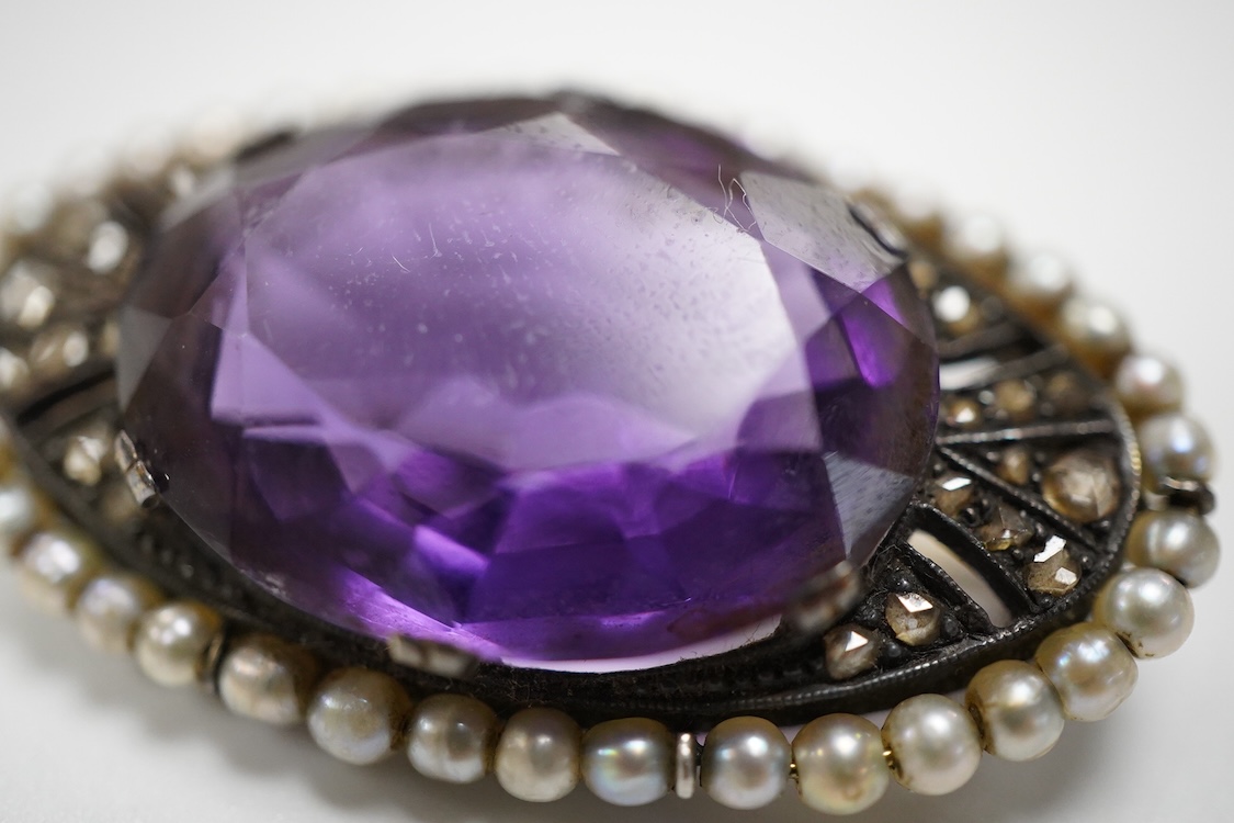 An early 20th century Austro-Hungarian 14k, amethyst, diamond and seed pearl set oval brooch, 37mm, gross weight 10 grams.